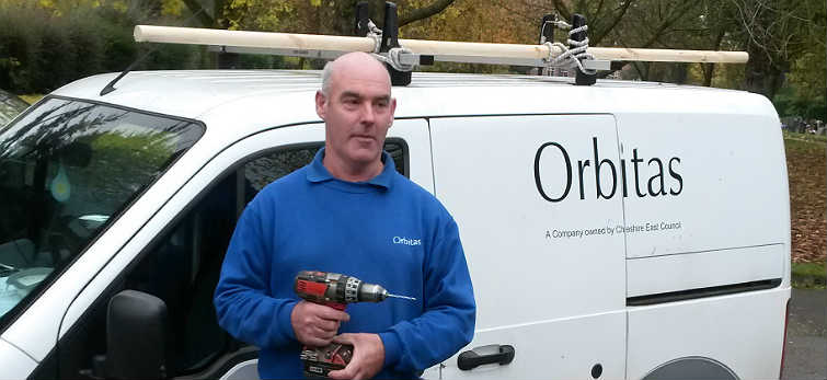Member of the Orbitas handyperson service team holding a drill